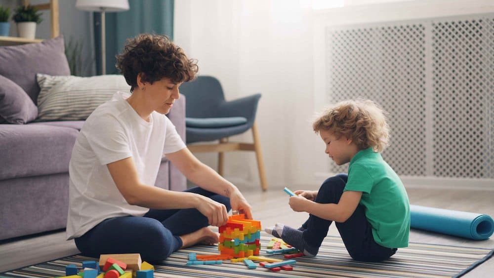 Play therapist working with child using creative play activities
