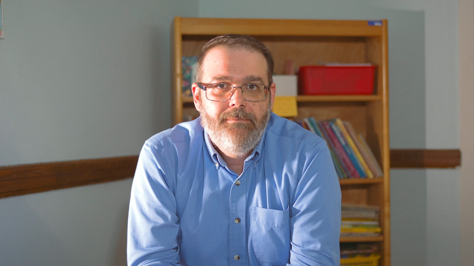 A Knowledge Road specialist at a desk in a school office
