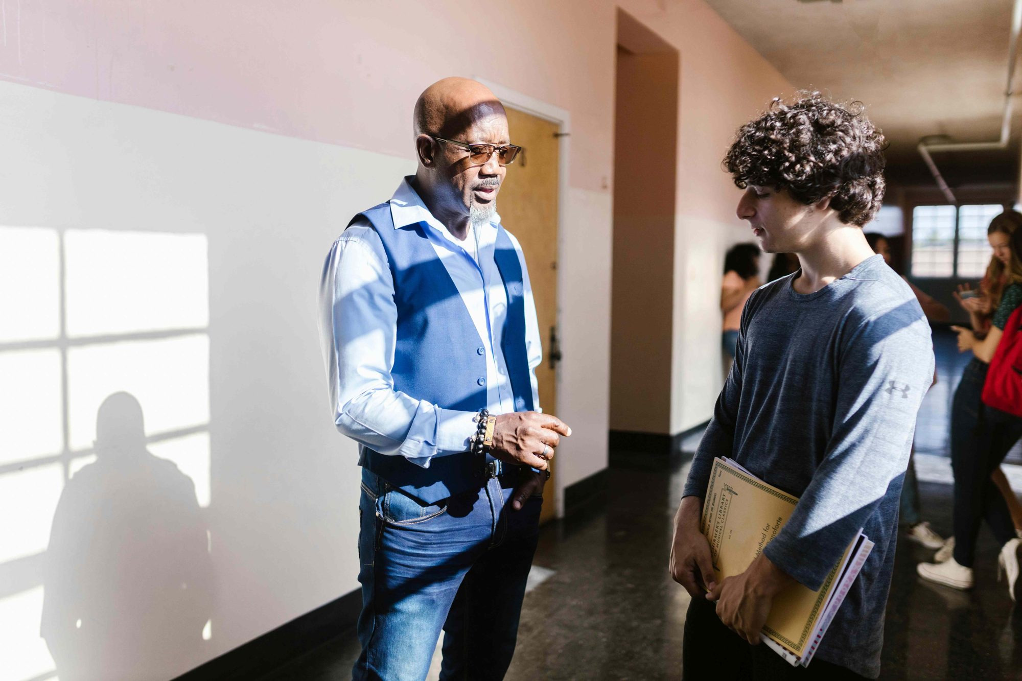 A Knowledge Road counselor talking with a student in a school setting