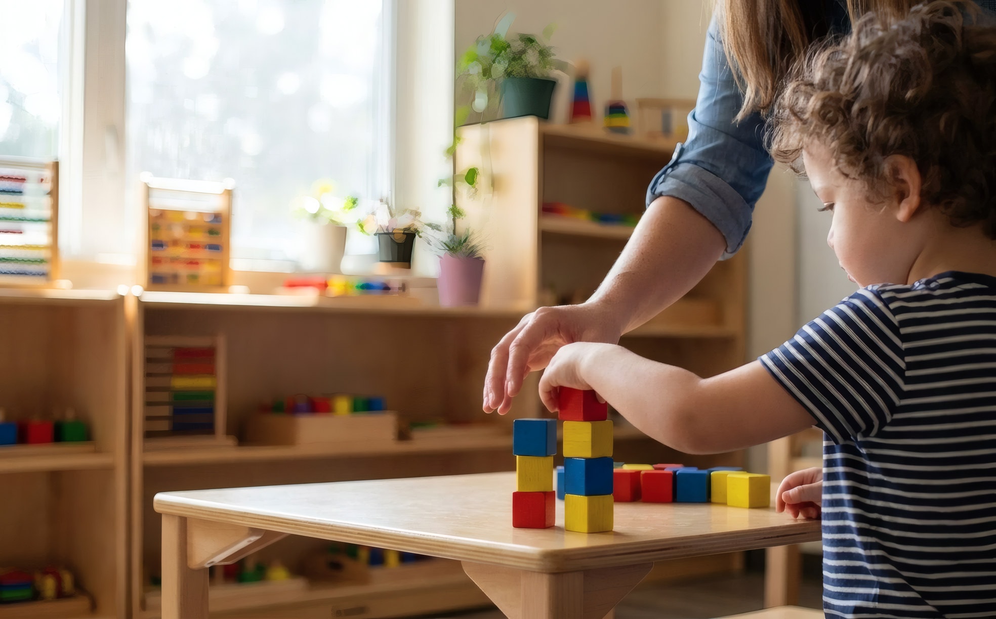 An early-childhood provider supporting a young child during a session